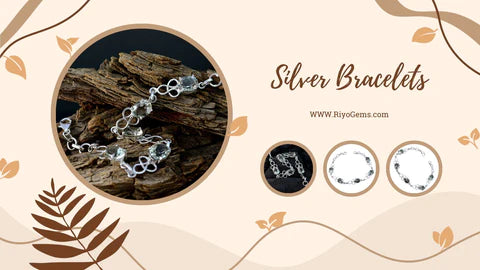 Stylish silver bracelets displayed on a wooden background, perfect for any occasion and answering can silver bracelets get wet