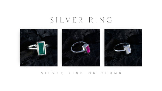 Stylish silver rings displayed on a black background illustrating silver ring on thumb benefits