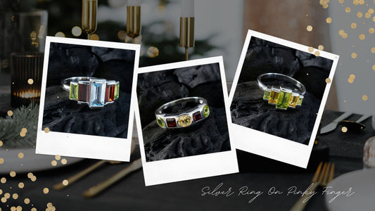 Stylish silver ring on pinky finger featuring colorful gemstones in an elegant setting